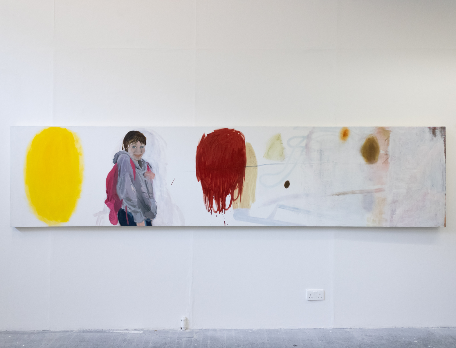 a long thin painting of two brightly coloured blobs and a portrait of a girl with a cheeky grin