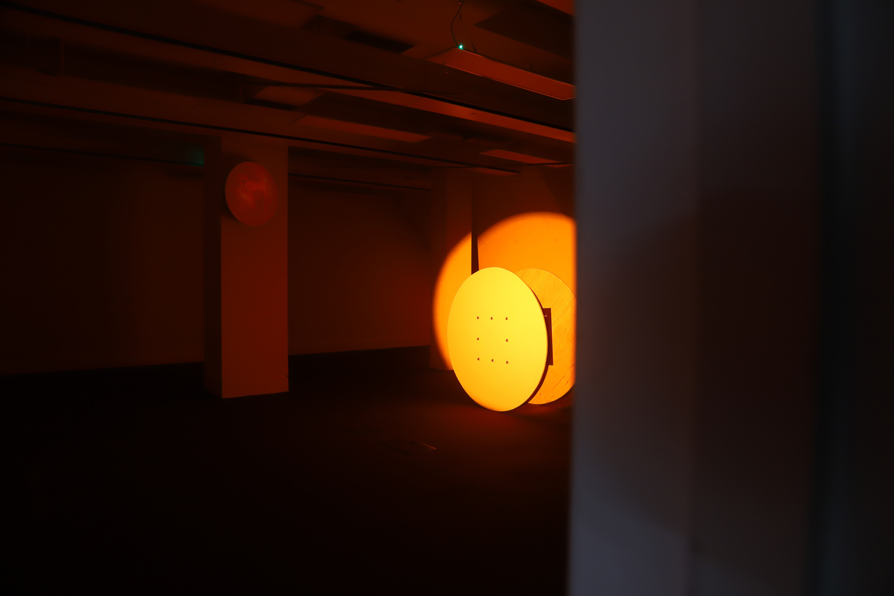 Installation in office, large circle on back wall, orange lighting